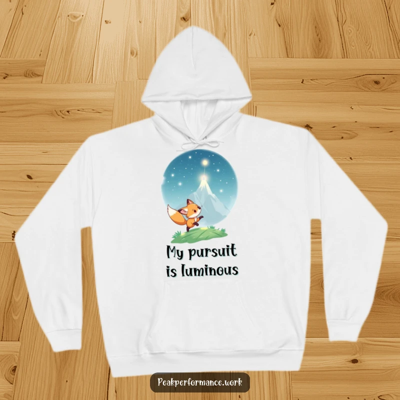 Funny Hoodie: Playful fox cub chases a shimmering light towards a peak, offering warm and humorous adventure.